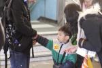 A child volunteer selling flags to the public